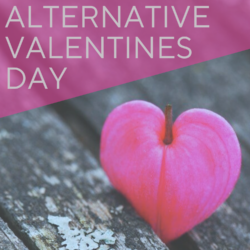 Alternative Valentine's Day event graphic with a pink heart-shaped flower resting on a wooden surface, overlaid with diagonal pink text.